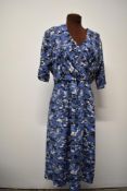 A 1940s / 1950s cotton day dress having novelty pagoda pattern and pleats to bust and skirt.