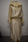 A cream silk 1980s two piece set, with hand embroidered flowers and matching belt.