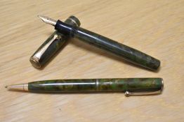 A Parker Moderne Duette Jr button fill fountain pen and propelling pencil set in green and gold