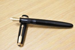 A Parker Duofold button fill fountain pen in black with decorative band to the cap having Parker