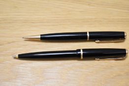 A Parker Duofold ballpoint pen and propelling pencil set in black with narrow decorative band.