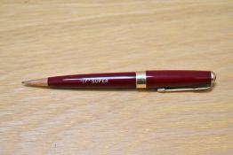 A Parker 17 Super propelling pencil in burgundy with broad band to the base of the cap