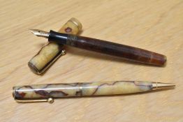 A Parker Moderne Duette button fill fountain pen and propelling pencil in cream with red lines