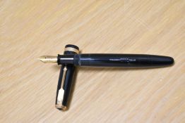 A Parker Duofold button fill fountain pen in dark blue with decorative band to the cap having Parker
