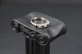 A sapphire and diamond half eternity ring having an illusionary setting on an 18ct white gold