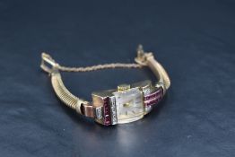 A 9ct gold cocktail watch by Aureole having baton numeral dial to rectangular face with convex glass