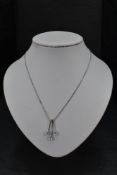 A 9ct white gold necklace having three teardrop aqua marines on bar drops on a fixed chain, approx