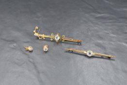 Two yellow metal bar brooches, one stamped 15ct, both having central aqua marines, and a pair of