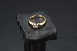 A four stone diamond square set ring having a central diamond chip,total approx 0.50ct, all in a