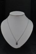 A 9ct white gold pendant having blue topaz and amethyst style stones in a rectangular mount on a 9ct