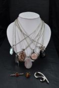 A small selection of pendants with chains, stamped 925 including polished stone, square locket, onyx