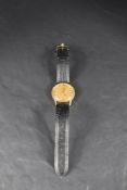 A gent's 1970's yellow metal automatic wrist watch by Omega having baton numeral dial and date