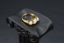 An opal trio ring having three graduated opal cabochon stones interspersed by diamond chips (one