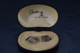 A pair of 9ct gold cufflinks having diamond chip and engraved decoration and bar fittings, appprox