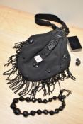A late Victorian handbag, having moulded vulcanite handle and faceted beaded necklace.