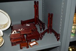 A selection of oriental hardwood display stands and folding plate racks, the largest stand