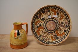 An early 20th Century Crown Ducal jug, decorated in an orange mottled glaze, measuring 19cm tall,