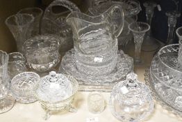 A collection of glassware, including cut glass fruit bowl, basket and vases, pressed glass jug and