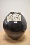A large oriental earthenware floor vase, having black glaze.