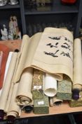 A large collection of oriental scrolled symbolic wall hangings.
