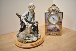 A cast Capo-di-Monte style shepherd figure, depicting a young boy sat on a tree stump, marked BA, on