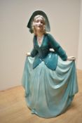 A German Art Deco Katzhutte Porcelain figurine, depicting gril in flowing green dress, printed