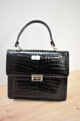 A vintage black patent handbag.