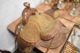 An impressive stitched and embossed leather North American 'Western' design saddle with looped