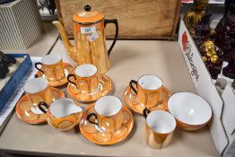 A Czechoslovakian Atlas China orange lustre porcelain coffee set, including sugar and cream, sadly