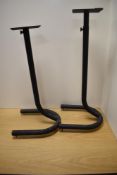 A pair of adjustable metal speaker stands, the U-form bases with adjustable points to underside