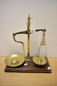 A set of W&T Avery classB brass beam scales, with wooden base and five graduating brass disc