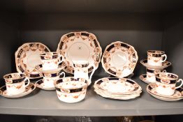 An Osbourne China teaset, decorated with gilt bands, repeating cobalt border and foliate swags, with