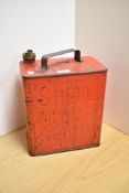 A vintage red-painted Shell Motor Spirit fuel can