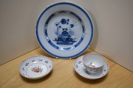 A 19th Century Delft glazed plate, possibly English, diameter 23cm, two Newhall porcelain saucers,