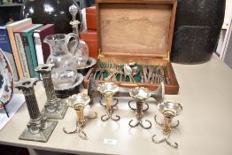 A pair of silver-plated Corinthian column candlesticks with rams head and swag ornaments to the