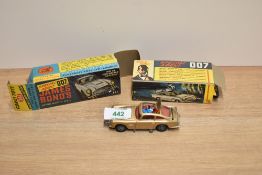 A Corgi die-cast, 261 James Bond's Aston Martin DB5, bandit and driver present, on inner card