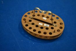 A traditional oak stand for communion or similar glasses