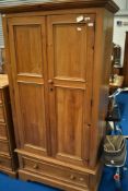 A modern pine wardrobe on drawer base, dimensions approx. H196 W91 D55cm