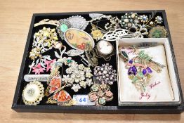 A collection of costume brooches of various designs including paste set Edwardian style bar