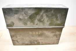 A vintage metal letter rack with lid, possibly military.