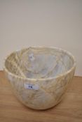 A contemporary variegated marble bowl, measuring 17cm tall