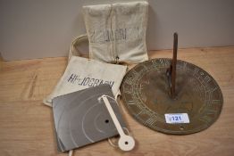 An antique brass sundial, having Welsh dragons to centre, approx 17cm, sold with a Heliograph