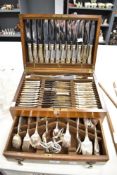 A vintage oak cased canteen of cutlery 'Super Stainless Community Sheffield Plate'.