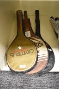 Three retro badminton rackets.