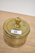A Victorian brass lidded candy jar, of circular form, measuring 11cm tall