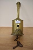 An early 19th Century brass roasting jack, John Linwood Warranted, with key, measuring 26cm tall