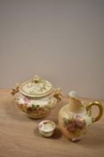 An early 20th Century Royal Worcester blush ivory lidded jar, measuring 12cm tall, together with a