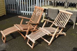 A pair of teak sun loungers, labelled Scancraft, Danish Design