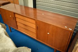A 1960s teak Troeds sideboard having four drawers to centre, flanked by cupboards , with sliding