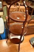 An Edwardian mahogany three tier cake stand having inlaid decoration